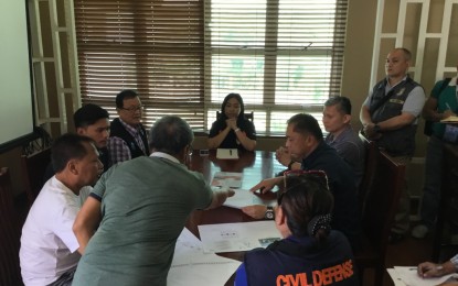 <p><strong>RESETTLEMENT PROGRAM.</strong> Naga City, Cebu Mayor Kristine Vanessa Chiong (center) listens to the officials from the National Housing Authority during their coordination meeting last October 2018 for the resettlement projects intended for the victims of landslide in Barangay Tinaan, Naga City, as other national government agency officials listen. <em>(Photo by John Rey Saavedra)</em></p>