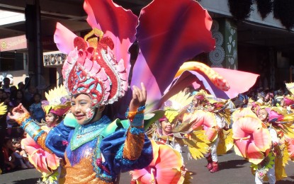 <p>A total of 24 street dancers clad in their elaborately designed costumes that portray the Philippine flowers swayed to different tunes during the grand street dancing parade of the 24th Baguio Flower Festival on Saturday. <em>(Photo by Pamela Mariz Geminiano) </em></p>