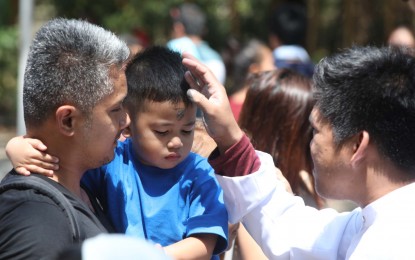 <p><strong>ASH WEDNESDAY</strong><em>. </em>A boy gets his forehead swiped with ash in the sign of the cross in this file photo. The Catholic Church has allowed the marking of crosses on the foreheads of the faithful during the celebration of Ash Wednesday this year on March 2. <em>(File photo) </em></p>