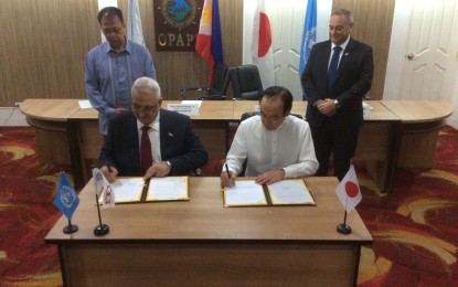 <p>ILO Philippines Director Khalid Hassan and Ambassador Koji Haneda sign the exchange of note on a project to ensure water and jobs in the Autonomous Region in Muslim Mindanao. Witnessing the signing are OPAPP Secretary Carlito Galvez Jr. and Food and Agriculture Organization Philippine Representative Jose Luis Fernandez. <em>(Photo by Joyce Ann L. Rocamora)</em></p>