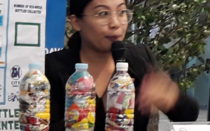 <p>HANNA CHLOE Cano, vice president for Business JCI-Duwaling and chairperson for Eco-brick Project, shows samples of the bottles full of  sachets of shampoo, candy wrappers to be used as materials for the construction of the learning center in Marilog in this March 4 photo. <em><strong>(PNA photo by Lilian C Mellejor)</strong></em></p>