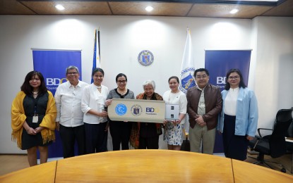 <p>The Department of Education (DepEd), led by Secretary Leonor Magtolis Briones and other DepEd officials, receives the second set of financial literacy videos from Banco de Oro Foundation and Bangko Sentral ng Pilipinas during the turnover ceremonies at the DepEd Central Office on March 13.<em> (Photo courtesy of DepEd)</em></p>