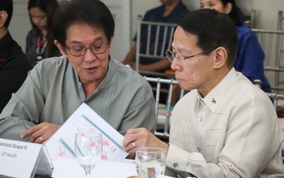 <p>Department of Health (DOH) Calabarzon regional director Eduardo Janairo shows Health Secretary Francisco Duque III the maps of municipalities with high number of measles cases in Rizal Province during the Emergency Command Conference on Measles at the Sulo Riviera Hotel, Quezon City on March 18, 2019. <em>(Photo courtesy of DOH Calabarzon)</em></p>