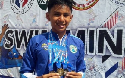 <p>Swimmer Philip Miguel Mendoza displays three  medals he won in in the Philippine Youth Games-Batang Pinoy Luzon qualifying leg in Ilagan, Isabela on Thursday (March 21, 2019). <em>(Photo courtesy of Sheryl Mendoza)</em></p>