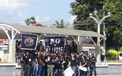 <p>Bataan riders hold a protest action to seek an amendment on the Motorcycle Crime Prevention Act, particularly on the double plates, at the Flaming Sword monument in Pilar, Bataan on Sunday. <em>(Photo by Ernie Esconde)</em></p>