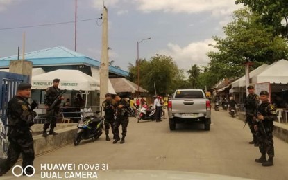 <p><strong>FULL ALERT.</strong> Police personnel guard a seaport in Negros Oriental in anticipation of attacks by the New People's Army in time for its 50th founding anniversary on March 29. <em>(Photo by Judy Flores Partlow)</em></p>