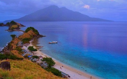 <p><strong>PARADISE.</strong> Sambawan Island in Maripipi town, Biliran province boasts of a semi-curved beach with soaring rock formations covered with green grass that serve as a backdrop to white sands, thriving marine life and warm blue waters lapping up the tree-lined shore. Eastern Visayas has been named as among the top local sites recommended for “revenge travel” in 2023 after two years of the pandemic lockdown. <em>(Photo courtesy of the Department of Tourism)</em></p>
