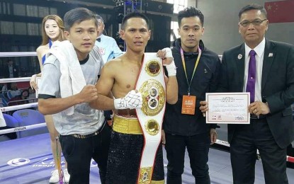 <p><strong>CHAMP.</strong> Undefeated boxing champ Jason “Smasher” Mama holds his champion belt. Mama is flanked by Sanman Boxing Promotions President JC Manangquil (right) and Markquil Salvana. (<em>Photo courtesy of Sanman Boxing Promotions)</em></p>