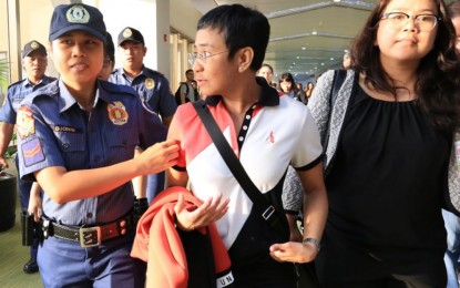 <p><strong>ARRESTED.</strong> A police officer escorts Rappler chief executive officer (CEO) Maria Ressa at the Ninoy Aquino International Airport upon her arrival from the US on Friday (March 29, 2019). Ressa was ordered arrested by the Pasig City Regional Trial Court Branch 265 on charges of violation of the Anti-Dummy Law <em>(Photo courtesy of NAIA Media Affairs Division)</em></p>