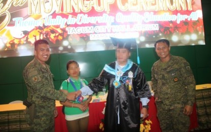 <p>Members of the 71st Infantry Battalion congratulate Peter (with Toga), a Salugpongan-turned Army army scholar, during a graduation ceremony of the Liceo de Davao Tagum College on March 29, 2019. <em>(Photo courtesy of 71st IB CMO)</em></p>