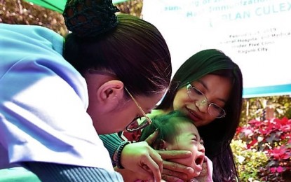 <p>A health worker administers an anti-measles vaccine during the launching of the mass vaccination program in Baguio City on February 12. <em>(PNA file photo)</em></p>