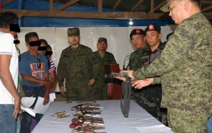 <p><strong>SURRENDERED FIREARMS.</strong> Lt. Col. Emelito Thaddeus Logan (right), commanding officer of the Army’s 79th Infantry Battalion (79IB), receives the firearms surrendered by former Yunit Militia members in a ceremony held at their headquarters in Sagay City on Sunday (March 31, 2019). The Yunit Militia is the local armed component of the Communist Party of the Philippines-New People's Army.<em> (Photo courtesy of 79IB, Philippine Army)</em></p>