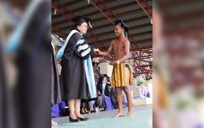 <p><strong>HIGHER EDUCATION</strong>. A Mangyan graduate wearing traditional garb is seen in this undated photo receiving his diploma after earning his Bachelor of Science in Agriculture degree. The town of Sablayan, Occidental Mindoro on Tuesday (Nov. 14, 2023) inaugurated a dormitory for the exclusive use of Mangyan students. <em>(PNA file photo)</em></p>