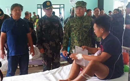 <p>Police Regional Office Cordillera Regional Director Brig. Gen. Israel Ephraim Dickson (3rd from left) awards the “Medalya ng Sugatang Magiting” to one of the wounded policemen who was hit by shrapnels after an anti-personnel mine exploded while pursuing New People'ss Army terrorists. Also in the photo are Mountain Province Governor Bonifacio Lacwasan (left) and PROCOR head of the directorial staff Police Col. David Peredo (center). <em>(Photo courtesy of PROCOR PIO)  </em></p>