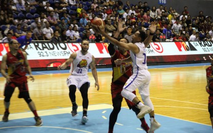 <p>Playmaker Jason Castro scores a huge layup off Junemar Fajardo's defense as TNT edged San Miguel Beer, 93-88, to force a deciding Game 3 in their PBA Philippine Cup quarterfinal series at the Araneta Coliseum on Monday (April 6, 2019). <em> (PNA photo by Jess Escaros) </em></p>