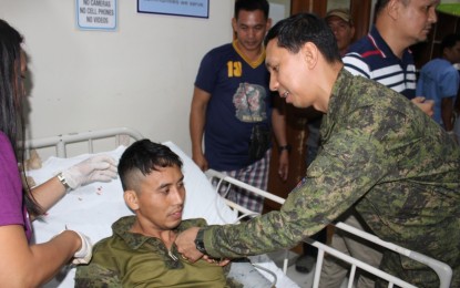 <p><strong>MEDAL FOR THE WOUNDED.</strong> Brig. Gen. Benedict Arevalo, commander of the 303<sup>rd</sup> Infantry Brigade, pins a medal on one of the seven soldiers wounded in a clash between the 62<sup>nd</sup> Infantry Battalion troopers and the New People’s Army (NPA) rebels in Himamaylan City, Negros Occidental on Tuesday (April 9, 2019). Troops encountered about 20 NPA fighters during a combat operation at Sitio Asaran in Barangay Buenavista. <em>(Photo courtesy of 303<sup>rd</sup> Infantry Brigade, Philippine Army)</em></p>