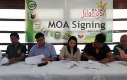 <p><strong>MOA SIGNING.</strong> Philippine Drug Enforcement Agency (PDEA) Western Visayas Acting Regional Director Alex M. Tablate  (left) and Passi City Mayor Jesry Palmares (second from left) with local chief executives of neighboring Iloilo towns sign a Memorandum of Agreement (MOA) for the operationalization of Balay Silangan Reformation Center in Passi City on Wednesday (April 17, 2019). Two reformation centers,  another one in Tapaz, Capiz, will open simultaneously on April 22 to cater to close to 50 drug pusher-surrenderers. <em>(Photo courtesy of PDEA 6)</em></p>