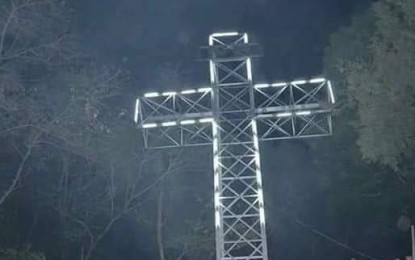 <p><strong>LIGHTED GIANT CROSS.</strong> The lighted 45-foot cross atop the Holy Mountain in Isabela town. At least 20,000 pilgrims are expected to visit the site this Holy Week.<em> (Photo courtesy of Grace Supe) </em></p>