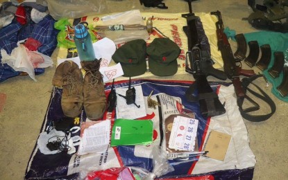 <p>Troops recover high-powered firearms with live ammunition and other items, including rifle grenades and subversive documents, after their encounter with CPP-NPA guerrillas in Calatrava, Negros Occidental last Wednesday which left three rebels dead. <em> (Photo courtesy of 79th Infantry Battalion, Philippine Army)</em></p>