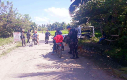 <p>Members of the Sultan Kudarat Provincial Mobile Force Company conduct checkpoint along a road in Barangay Pimbalayan, Lambayong, Sultan Kudarat following the discovery of two IEDs in a chapel nearby on Monday, April 22, 2019. <em><strong>(Photo courtesy of Lambayong MPS)</strong></em></p>