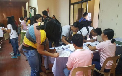 <p><strong>JOB FAIR.</strong> Job seekers fill out application forms during the Bantayog Festival Job Fair 2019, held recently by the labor department and the province's Public Employment Service Office at the Little Theatre of the Provincial Capitol in Daet, Camarines Norte. A total of 118 applicants were hired on the spot in the job fair. <em>(Photo courtesy by Renalyn Alano)</em></p>