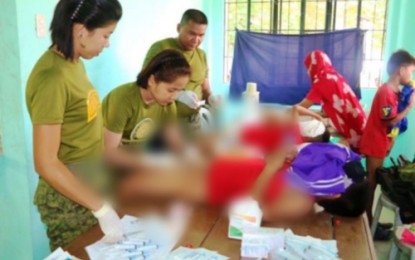 <p><strong>HEALTH SERVICES FOR INDIGENTS.</strong> Female health personnel of the Army’s 90th Infantry Battalion conducts circumcision on several children in Talitay, Maguindanao. <em>(Photo courtesy of 90th IB)</em></p>