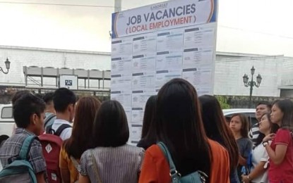 <p><strong>JOB FAIR.</strong> Job seekers look at the posted vacancies during the Labor Day job and business fairs held at the Kingsborough International Convention Center in the City of San Fernando, Pampanga on Wednesday, May 1, 2019. More than 10,000 jobs were available for local and overseas employment in the one-day labor activity. <em>(Photo courtesy of PIA-Central Luzon)</em></p>