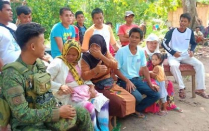 <p><strong>INFO CAMPAIGN.</strong> A soldier of the Army’s 33rd Infantry Battalion explains to local residents the perils of joining  the communist rebel movement during an information drive in  Bagumbayan town, Sultan Kudarat, Wednesday. <em><strong>(Photo by 33rd IB)</strong></em></p>