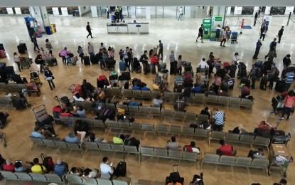 <p>Passengers waiting at NAIA Terminal 1 <em>(PNA Photo by Cristina Arayata)</em></p>