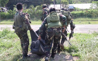 <p><strong>SLAIN REBEL</strong>. Soldiers carry the body of a New People's Army (NPA) member killed in a clash in Las Navas, Northern Samar Sunday night (May 6, 2019). Government troops have stepped up their patrol operation against rebels as the NPA has been reportedly attempting to collect permit to campaign fees from some politicians. <em>(Photo courtesy of Philippine Army's 20th Infantry Batallion) </em></p>