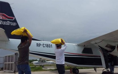 <p><strong>CLOUD SEEDING.</strong> Personnel of the Bureau of Soils and Water Management (BSWM) of the Department of Agriculture (DA) carry sacks of fine salt for loading into the BN-2 Islander airplane to be used for cloud seeding operations in Bulacan on Monday (May 6, 2019). The move is to create artificial rain that could increase the level of water of dams in the province, particularly in Angat Dam which is the major source of water supply for Metro Manila. <em>(Photo by Manny Balbin)</em></p>