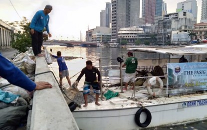 <p><strong>TOP PLASTIC POLLUTER</strong>. A photo taken on May 9, 2019 shows workers unloading sacks of garbage hauled from Pasig River which Rotterdam-based Ocean Cleanup identified as the top plastic-emitting river in the world. Malacañang on Thursday (June 10, 2021) said it is hoping that “with this badge of dishonor”, concerned government agencies would take radical steps to rehabilitate Pasig River. (File photo)</p>