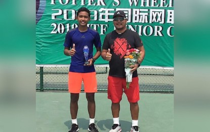 <p><strong>BACK-TO-BACK CHAMPION.</strong> Arthur Craig Pantino (left) holds his trophy after winning the singles title at the ITF China Junior 8 tournament in Beijing on Saturday. Beside him is coach Jun Toledo, a former Philippine Davis Cupper. <em>(Contributed photo)</em></p>