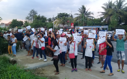 <p><strong>NO TO VOTE-BUYING</strong>. Around a hundred protesters flash “Not to Vote Buying” placards in front of a gubernatorial bet’s house in Bay, Laguna after a village councilor and a supporter were caught distributing sample ballots allegedly bearing the name of reelectionist Laguna governor and the party slate with money attached at a sub-village in the capital town of Sta. Cruz, on May 12, 2019. <em>(Photo by Saul E. Pa-a) </em></p>