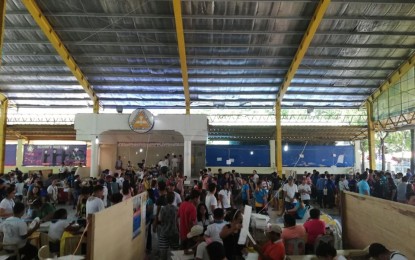 <p><strong>ELECTION DAY</strong>. Thousands of residents of Barangay Holy Spirit in Quezon City wait for their turn to vote as two of the vote counting machines malfunctioned during Monday's mid-term elections. <em>(Photo by Filane Cervantes)</em></p>