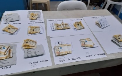 <p><strong>PROOF.</strong> Sample ballots and cash seized by the police from a group of 28 persons in Moises Padilla, Negros Occidental on Sunday night (May 12, 2019). All, except for the three minors, intercepted will face charges for violation of the Omnibus Election Code.<em> (Photo courtesy of Dolly Yasa) </em></p>
<p> </p>