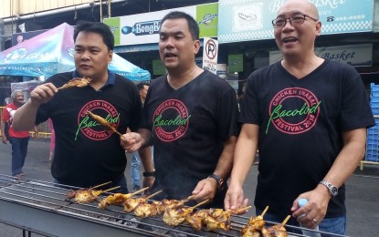 <p><strong>BBQ FEAST.</strong> (From left) Bacolod City Lone District Rep. Greg Gasataya, former councilor Bobby Rojas, and Vice Mayor El Cid Familiaran join the fun in grilling chicken during the 1<sup>st</sup> Bacolod Chicken Inasal Festival held in May last year. This year’s edition, set on May 25, will still feature 300 meters of barbecue grills along Araneta Street. <em>(File photo by Nanette L. Guadalquiver)</em></p>
<p> </p>