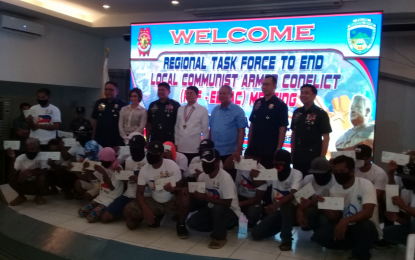 <p><strong>BACK TO THE FOLD OF THE LAW. </strong>DILG Secretary Eduardo Año (center) is joined by members of the multiagency Regional Task Force To End Local Communist Armed Conflict (RTF-ELCAC) in the Calabarzon Region during the formal turnover rites of  20 surrendered rebels who are now under the government’s Enhanced Comprehensive Local Integration Program providing livelihood assistance to the rebels as they live normal lives, during the RTF-ELCAC conference at the Police Regional Office (PRO4A) multipurpose hall, Camp Gen. Vicente Lim, Calamba City on May 17, 2019. <strong><em>(Photo by Saul E. Pa-a)</em></strong></p>