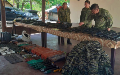 <p><strong>SEIZED WEAPONS. </strong> Military officials from the Army’s 6th Infantry Division inspect the assorted high powered guns and explosives seized by government forces from private armed groups in Talitay, Maguindanao on Friday (May 17, 2019). The 6th ID is continuously pursuing the armed groups in the area. <em>(Photo courtesy of 6ID)</em></p>