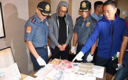 <p><strong>NABBED.</strong> National Capital Region Police Office Chief, Major Gen. Guillermo Eleazar inspects the illegal drugs and other items seized from Domingo Tanyao Uy Jr. who was arrested Shangri-la at the Fort before dawn Wednesday (May 22, 2019). <em>(Photo by Lloyd Caliwan)</em></p>