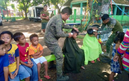 <p><strong>BRIGADA ESKWELA LINK.</strong> Soldiers from the Army's 33rd Infantry Battalion provide free haircut to pupils during the Brigada Eskwela activity on Thursday (May 23) in Datu Paglas, Maguindanao ahead of the class opening on June 3. <em>(Photo courtesy of 33rd IB)</em></p>