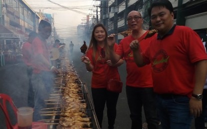 <p><strong>GRILLED CHICKEN FEAST</strong>. (From right) Bacolod City Lone District Rep. Greg Gasataya, Vice Mayor El Cid Familiaran, and Councilor Cindy Rojas lead the staging of the 2nd Bacolod Chicken Inasal Festival on Saturday. Some 3,000 chicken on sticks were grilled along the festival site on Araneta Street. <em>(Photo by Nanette L. Guadalquiver)</em></p>