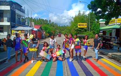 <p><strong>BE PROUD. </strong>Members of the San Julian Pride Advocacy Group -- who are lesbian, gay, bisexual, and transgender -- take pride in setting up the first rainbow-colored Pride crosswalk along the national road of San Julian, Eastern Samar. The 10-meter crosswalk is a symbol of the group's fight for equality and recognition, their founder said on Tuesday (June 4, 2019). <em>(Photo courtesy of San Julian Pride Advocacy Group)</em></p>