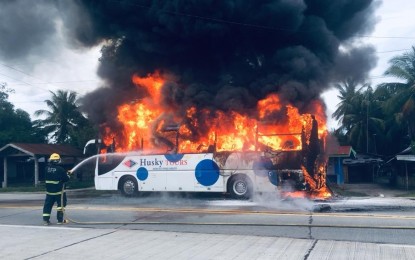 <p style="text-align: left;"><strong>BUS ON FIRE.</strong> A firefighter tries to put out the flames that engulfed a Husky Tours passenger bus unit along the national highway in Tantangan, South Cotabato on Monday afternoon, June 3. All 40 bus passengers were safely evacuated during the incident.<em>(Photo courtesy of the Tantangan-Bureau of Fire Protection)    </em> </p>