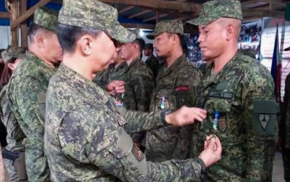 <p><strong>AWARDED.</strong> Brig. Gen. Benedict Arevalo, commander of the 303rd Infantry Brigade, pins the Military Commendation Medal on one of the troops of the 79th Infantry Battalion based in Barangay Bato, Sagay City in Negros Occidental on Tuesday (June 4, 2019). The soldiers were recognized for demonstrating exemplary performance of duties in combat operations against the New People’s Army.<em> (Photo courtesy of 303<sup>rd</sup> Infantry Brigade, Philippine Army)</em></p>