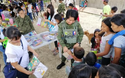 <p><strong>COUNTER-INSURGENCY STRATEGY.</strong> Soldiers of the Philippine Army’s 93<sup>rd</sup> Infantry Battalion (93rd IB) join a gift-giving activity in Leyte as part of its counter insurgency strategy. The absence of violent activities perpetrated by armed rebels in Leyte Island this year is an indication that the group is becoming irrelevant, Capt. Ronald Odchimar, acting executive officer of the 93rdIB, said on Thursday (June 6, 2019).  <em>(Photo courtesy of 93<sup>rd</sup> Infantry Battalion)</em></p>