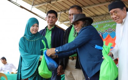 <p><strong>EID’L FITR CELEBRATION. </strong><br />Abdullah Macapaar (2nd from right), a Moro Islamic Liberation Front (MILF) commander and now a member of the Bangsamoro Transition Authority (BTA), leads distribution of food packages during Eid’l Fitr celebration at Camp Bilal in Munai Lanao del Norte on June 5, 2019. Officials of the Office of the Presidential Adviser on the Peace Process, Armed Forces of the Philippines and MILF joined Muslims and Christians in the celebration of Eid’l Fitr, the culmination of the month-long observance of Ramadan, Camp Bilal. <em>(Photo by OPAPP Communications and Public Affairs)</em></p>