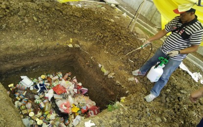 <p><strong>ASF PREVENTION. </strong> Some 244 pieces of canned goods and other raw and processed foods are buried in a dumpsite in Cabatuan, Iloilo on Tuesday (June 4, 2019). Regional Veterinary Quarantine Officer Dr. John Rhoel Hilario said the goods were confiscated from arriving passengers at the Iloilo International Airport, mostly coming from Hong Kong. <em>(Photo courtesy of Veterinary Quarantine Region 6)</em></p>