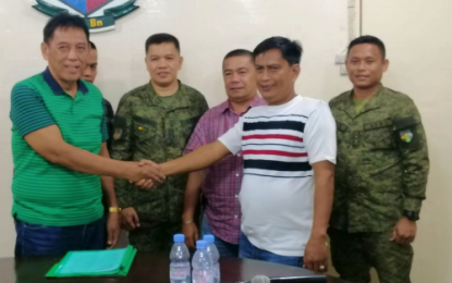 <p><strong>FEUD SETTLEMENT.</strong> Mando Tabungalan (left) and Datu Tamano Mamalapat shake hands after their “rido” (family feud) settlement by the Army’s 1st Mechanized Infantry Battalion in Maguindanao on Friday, June 7, 2019. <em><strong>(Photo courtesy of 1st MIB)</strong></em></p>
