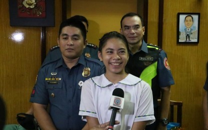 <p><strong>GUARDIAN COP. </strong>Grade 7 student Angela Perez speaks to reporters about Police Corporal Claro Fornis (left) who helped her enroll at the General Pio Del Pilar National High School through acting as her guardian on Tuesday (June 11, 2019). Also in the photo is NCRPO chief, Major Gen. Guillermo Eleazar. <em>(Photo courtesy: NCRPO PIO)</em></p>